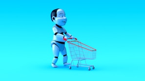A humanoid robot with exaggerated features is pushing a small shopping cart against a bright blue background. The robot has a shiny, metallic finish with black and white segments, and the shopping cart has a red handle and frame.