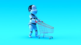 A humanoid robot with exaggerated features is pushing a small shopping cart against a bright blue background. The robot has a shiny, metallic finish with black and white segments, and the shopping cart has a red handle and frame.