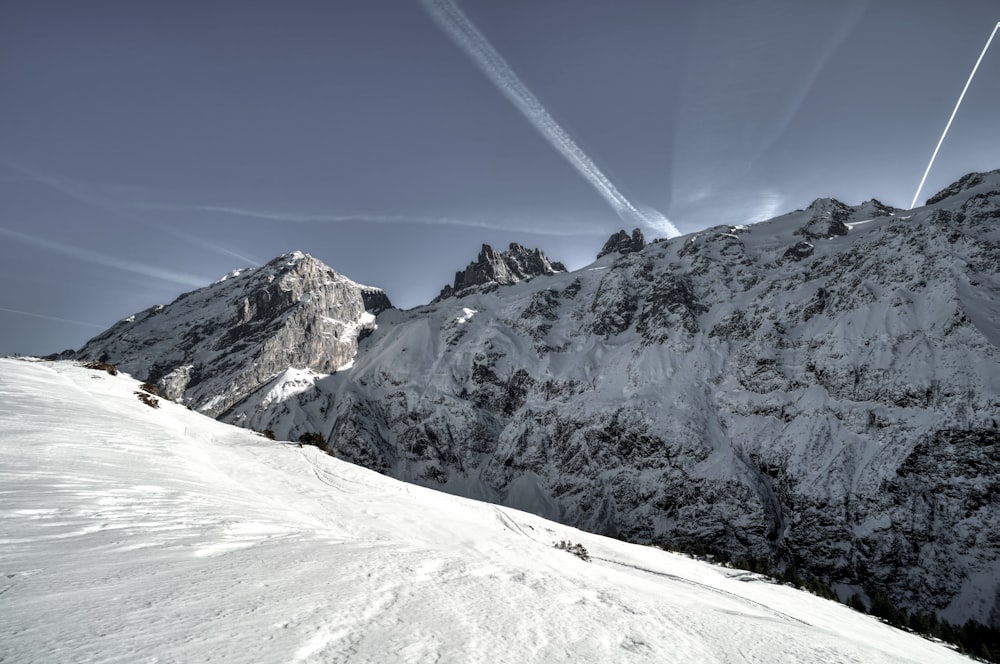 a person riding skis down a snow covered slope