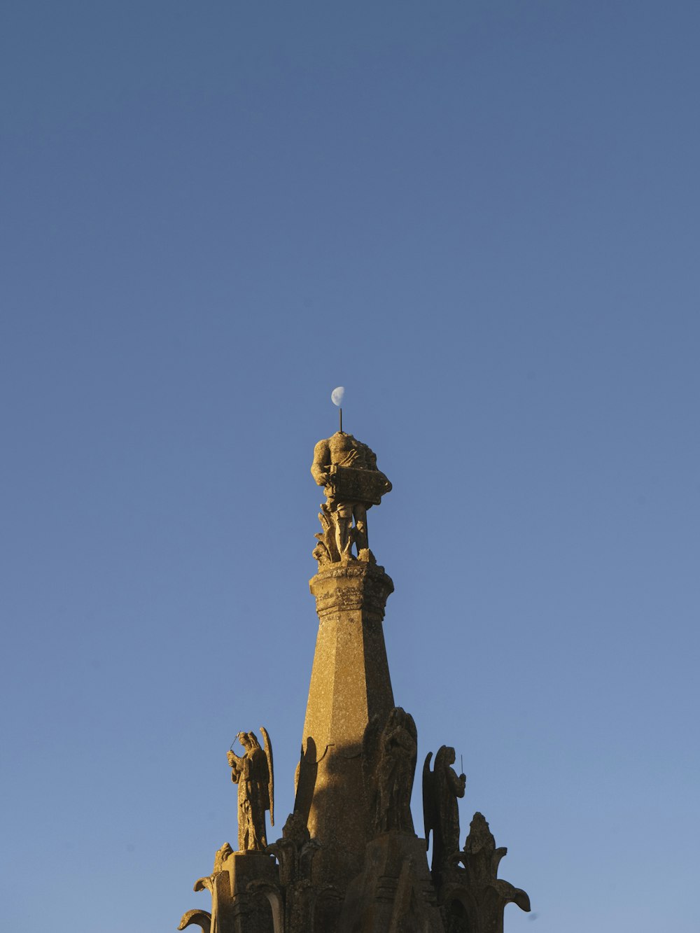 a tall tower with statues on top of it