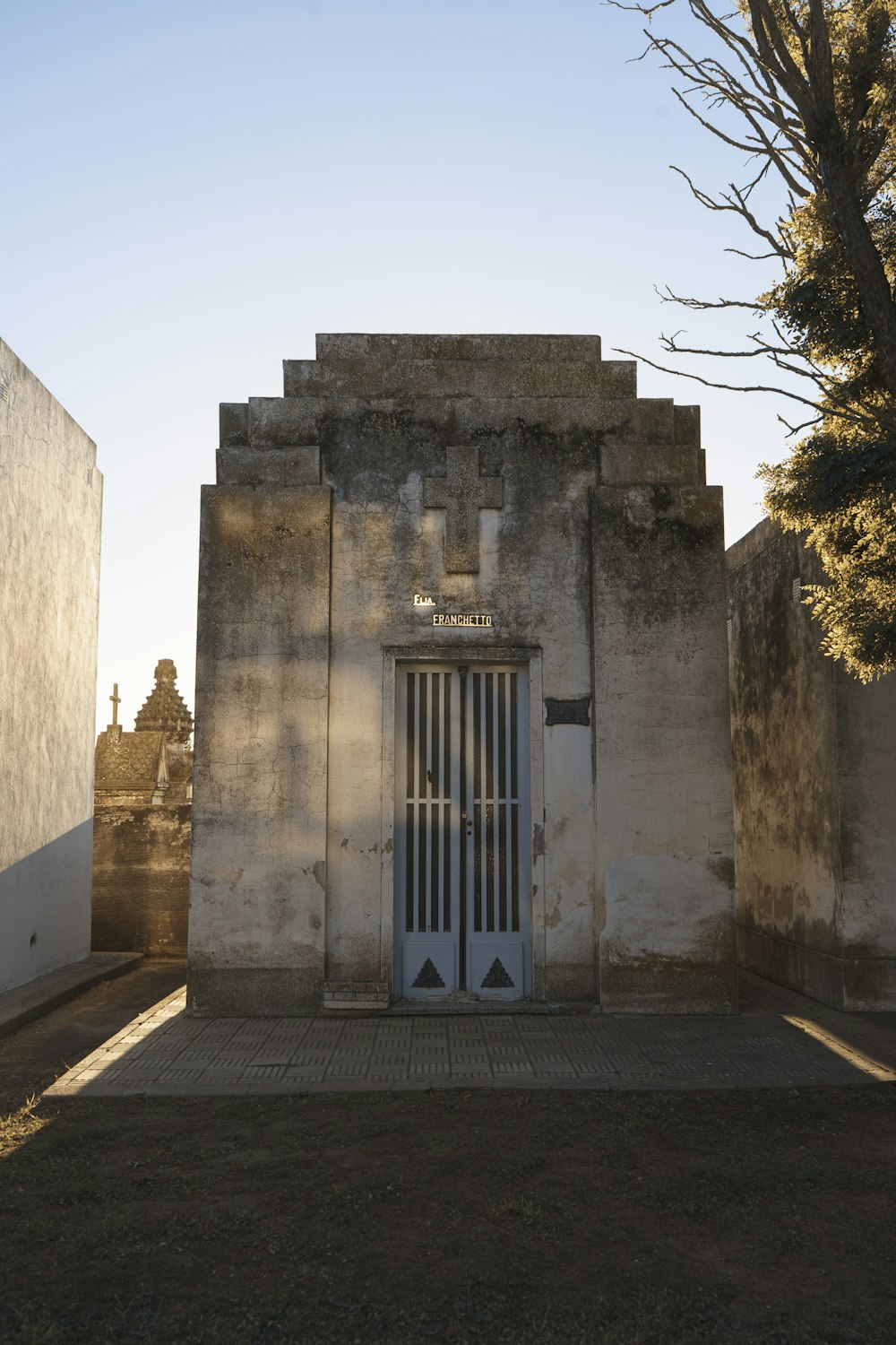 an old building with a door and bars on it