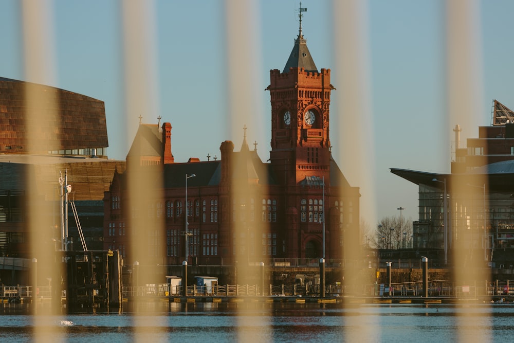 a view of a clock tower from across a body of water