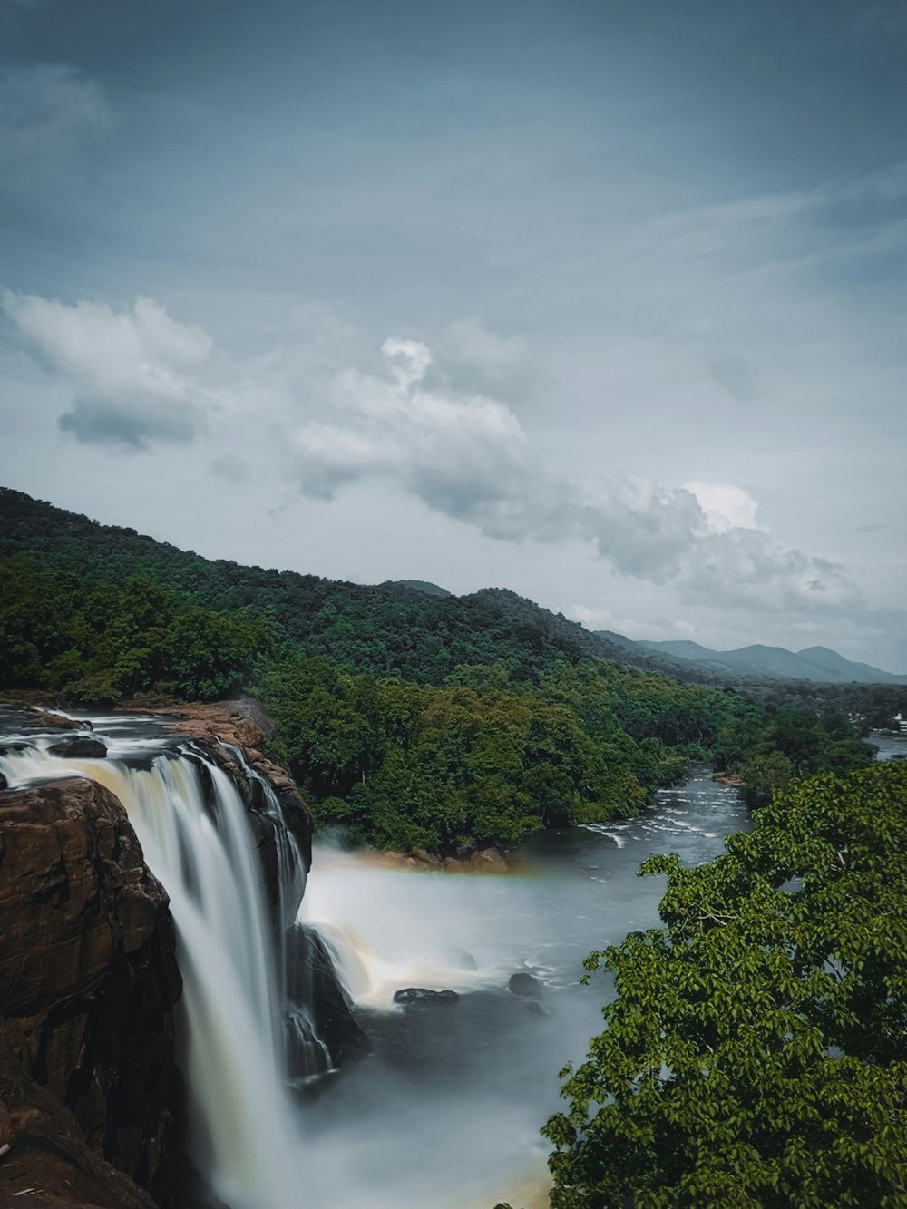 a waterfall in the middle of a forest