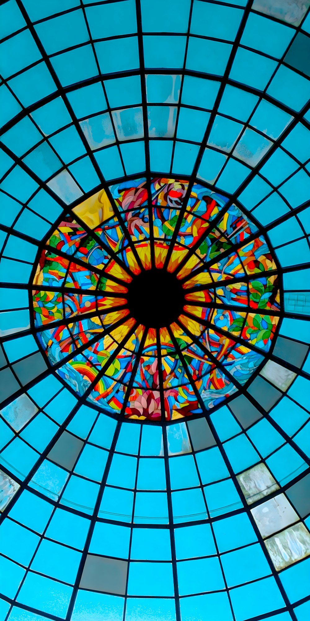 a stained glass ceiling with a circular window
