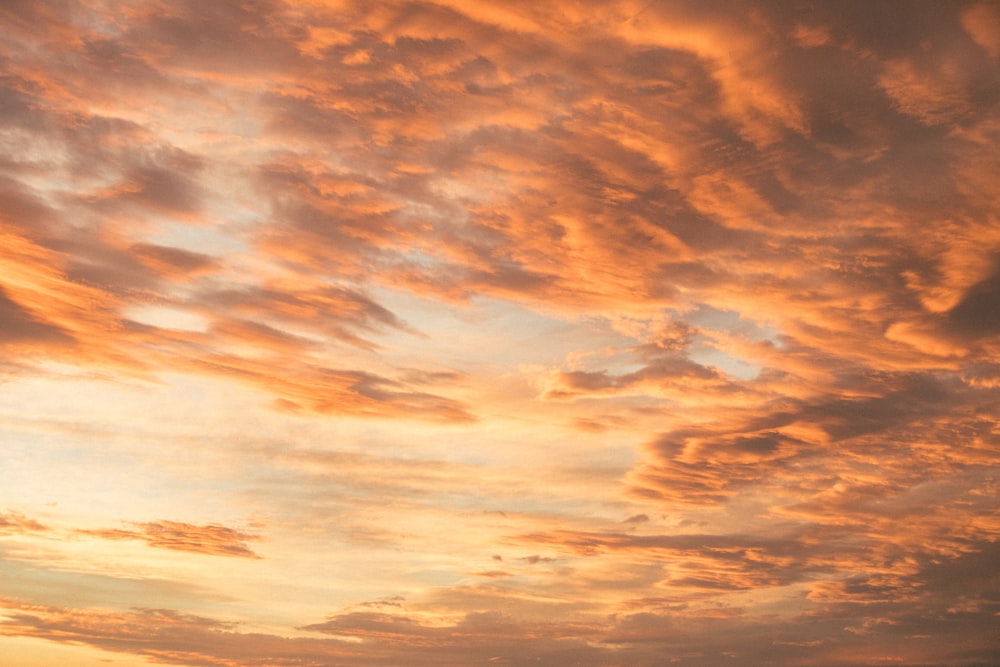 a plane is flying in the sky at sunset