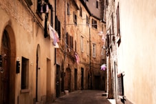 a narrow alley way with clothes hanging on the clothesline