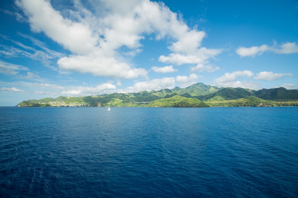 a large body of water with mountains in the background