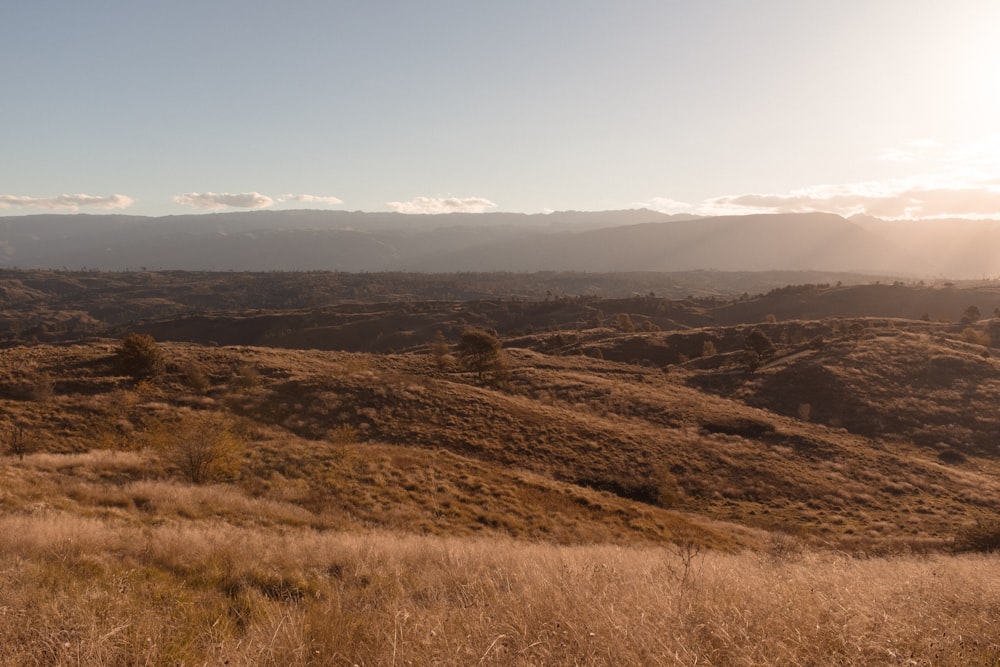 the sun is shining on the mountains in the distance