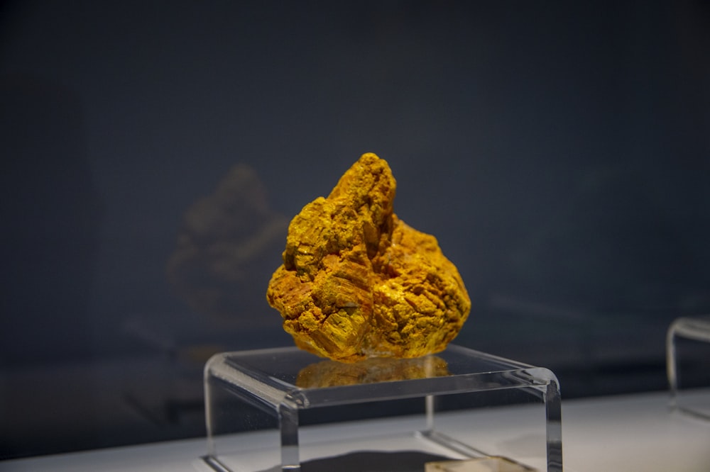 a yellow rock sitting on top of a table