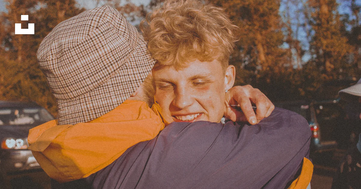 Hugging A Lod Two people hugging each other in a parking lot photo – Free Wallpaper ...