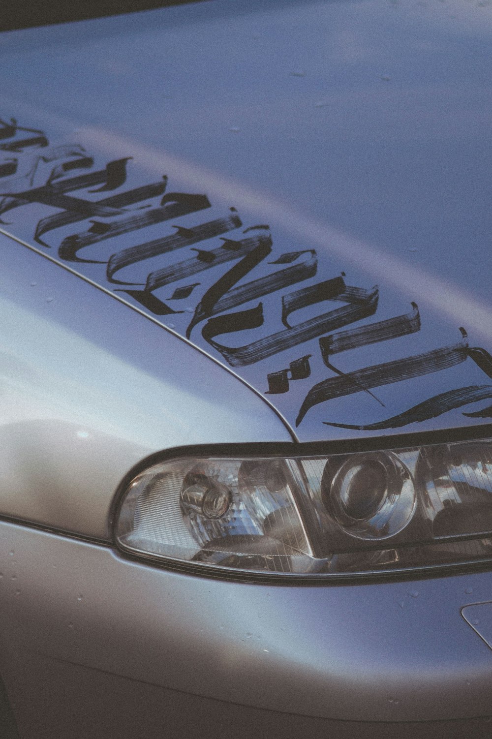 a close up of the front of a silver car