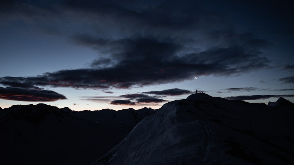 a person standing on top of a snow covered mountain