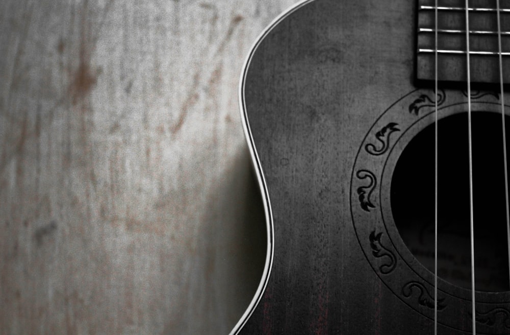 a close up of a black acoustic guitar