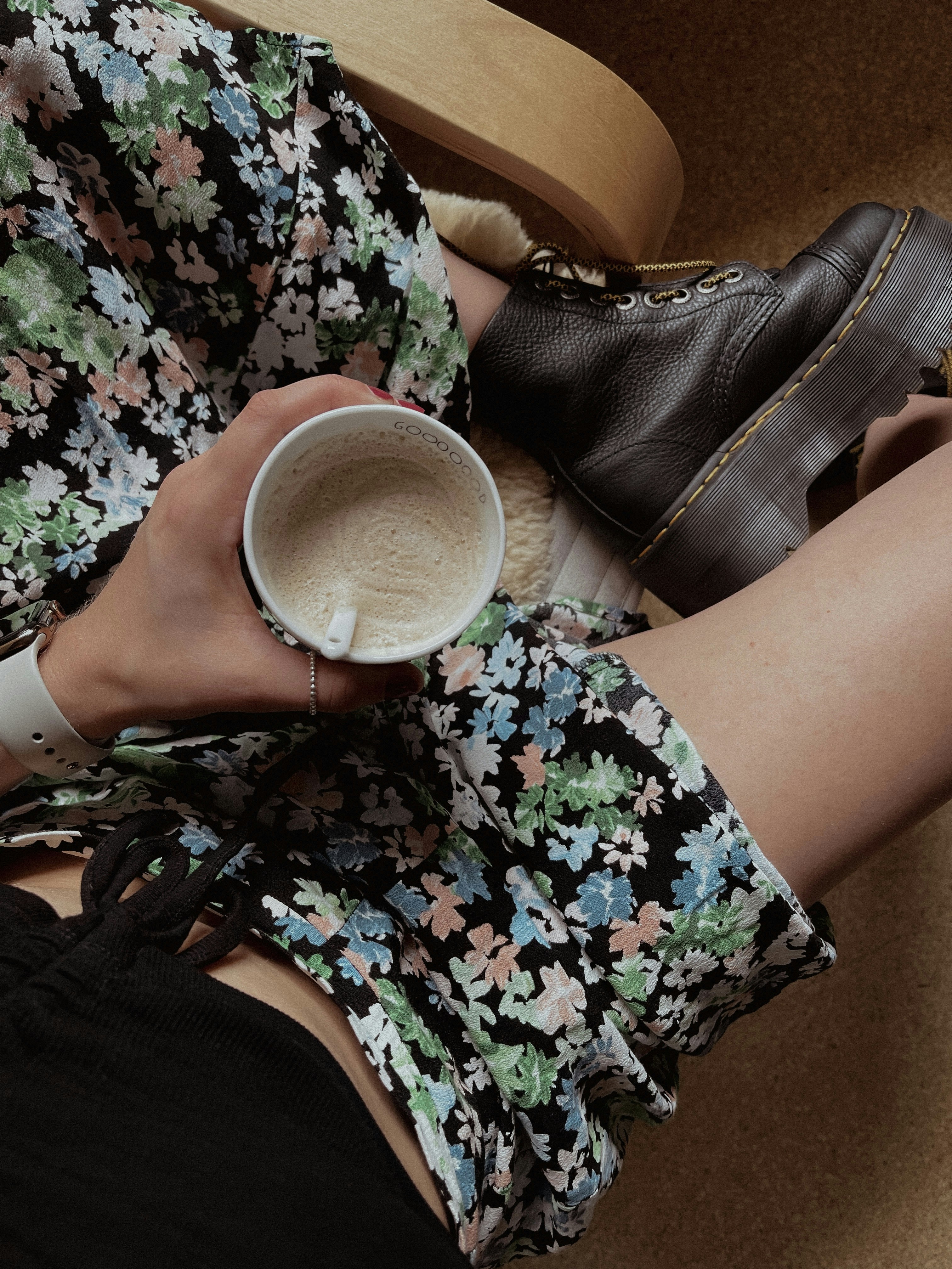 a woman sitting on a chair holding a cup of coffee