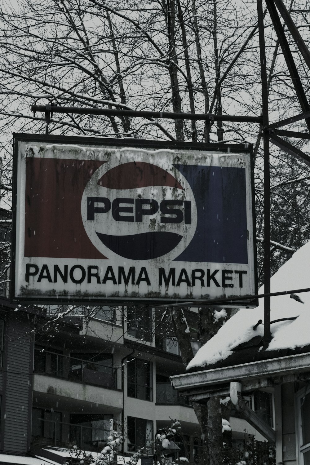 a pepsi sign hanging from the side of a building