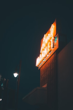 A vibrant illuminated sign glowing at night.