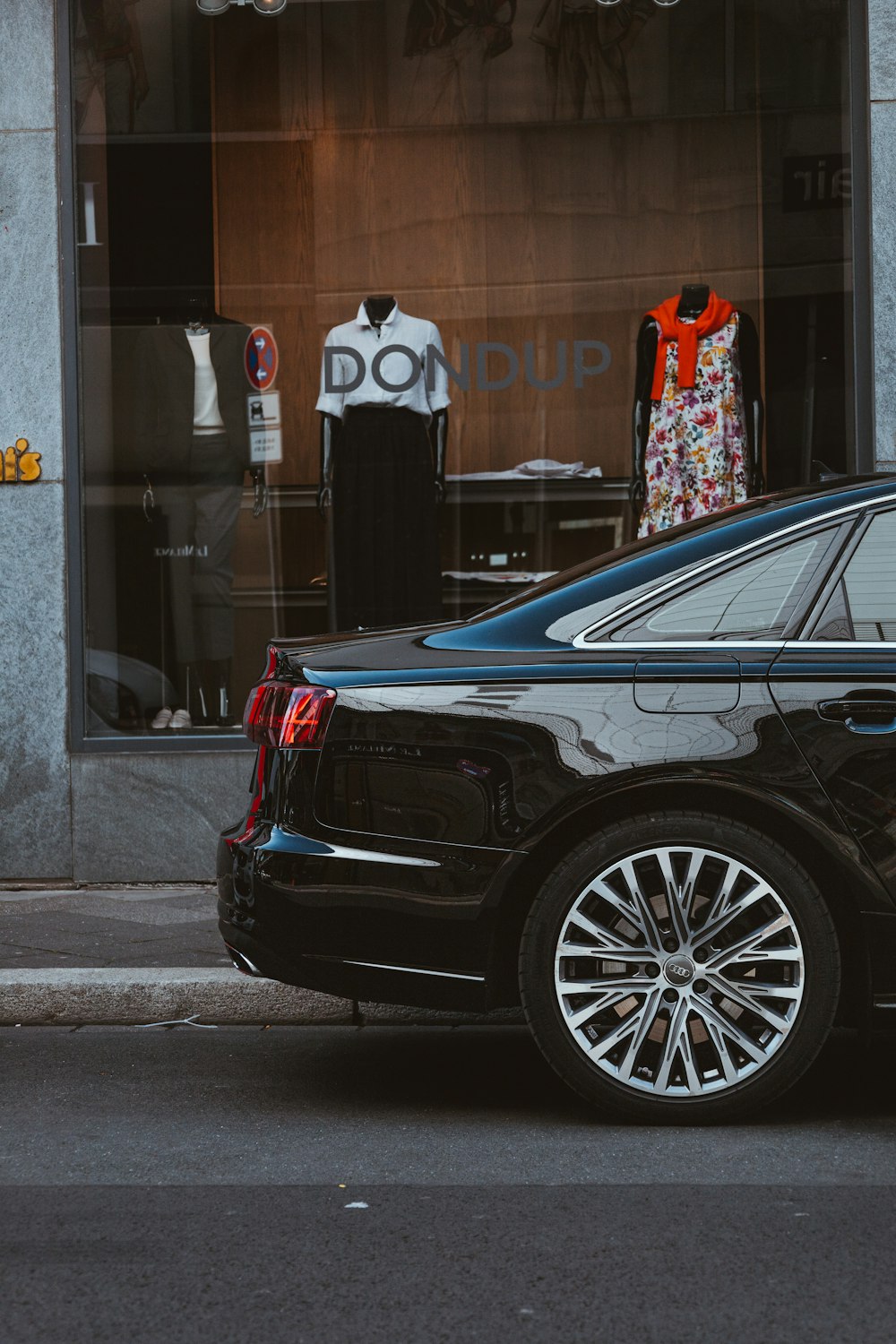 a black car parked on the side of the road