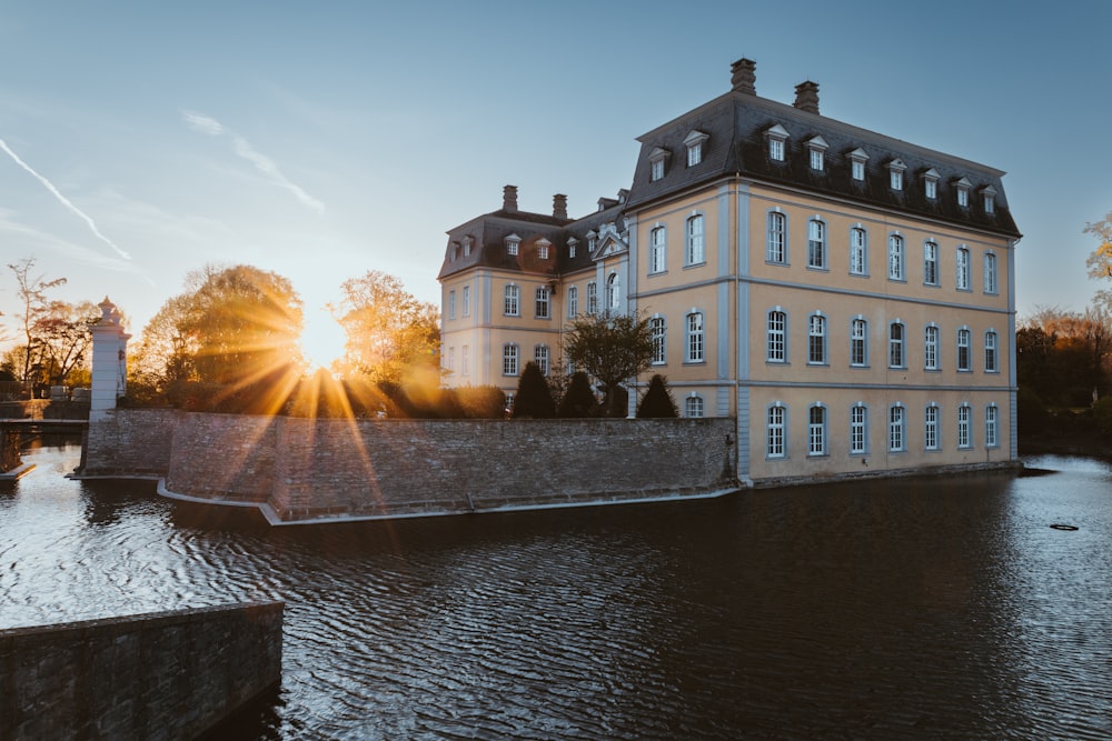 a large building sitting on the side of a river