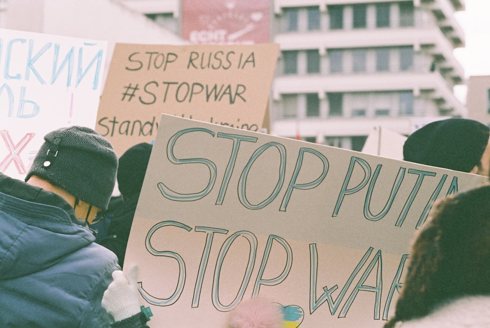 a group of people holding signs in a protest