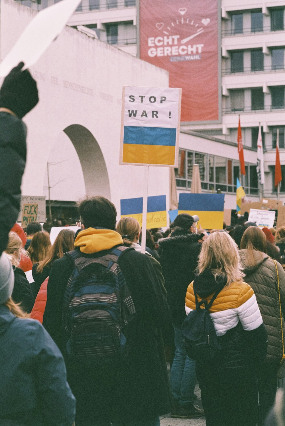 a crowd of people walking down a street