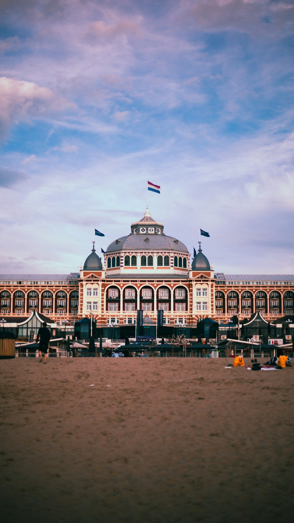 a large building sitting on top of a sandy beach