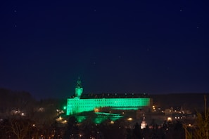 Evening view of the institute building illuminated against the Tartu skyline.