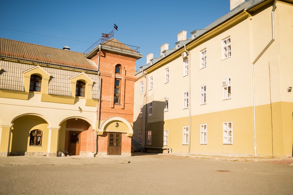 a yellow building with a clock tower on top of it