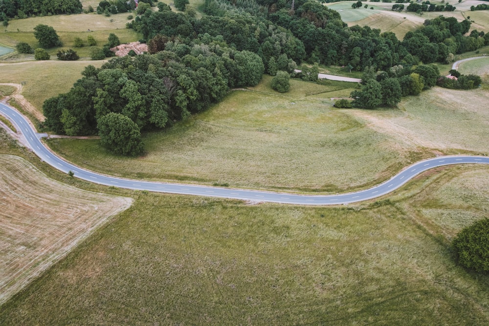 an aerial view of a winding country road