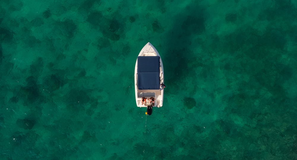 a small boat floating on top of a body of water