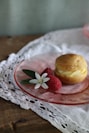 a muffin and a raspberry on a glass plate