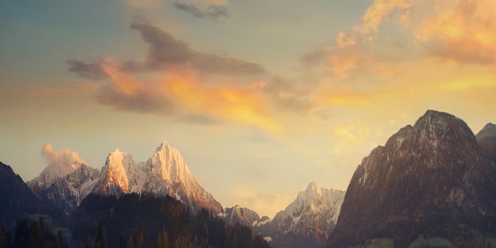a painting of a mountain range at sunset