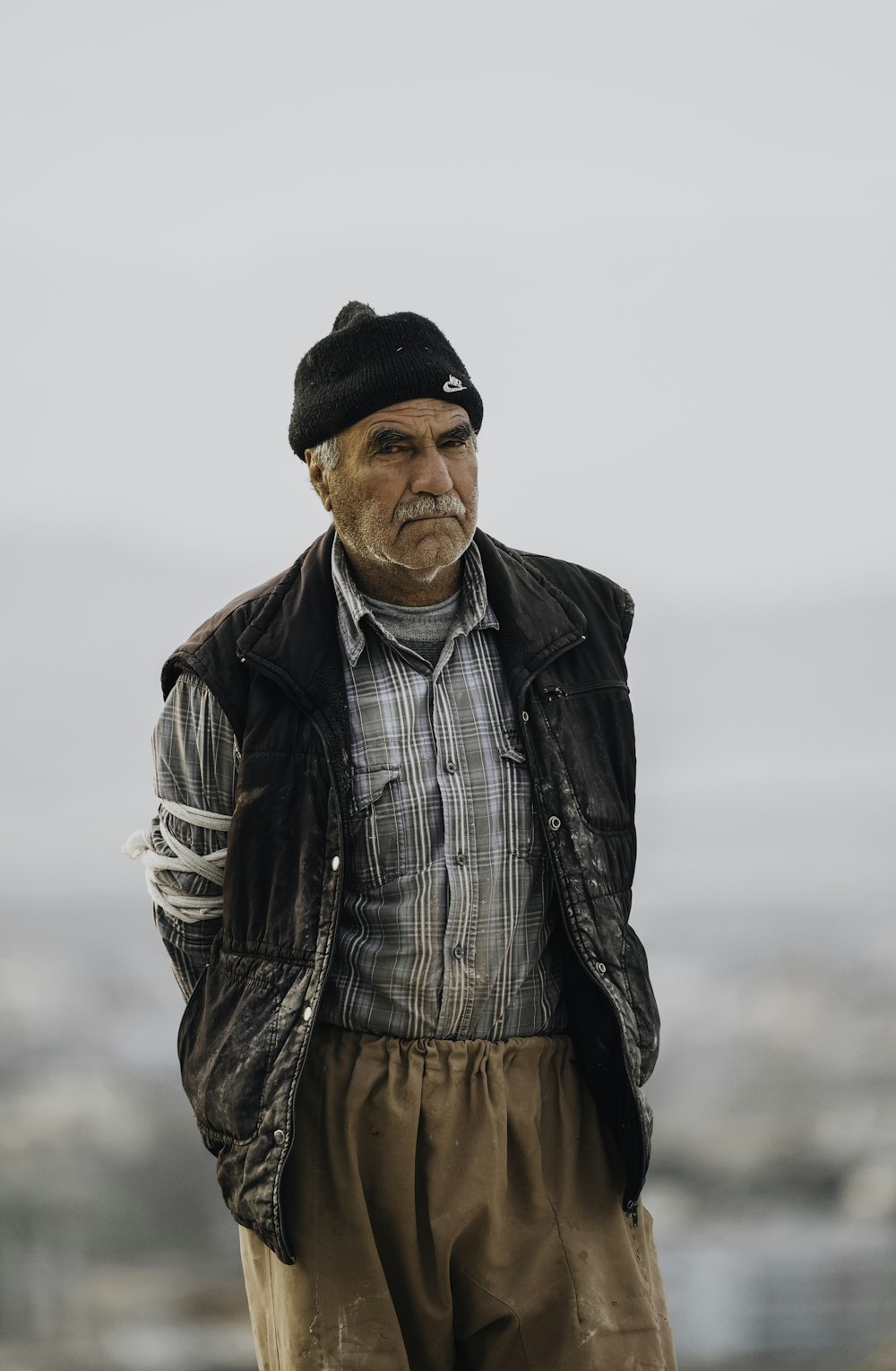 an old man wearing a hat and jacket