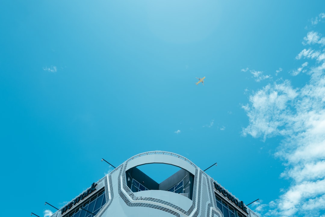a large jetliner flying through a blue sky,