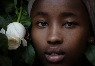 A close-up of a vivid portrait blending human features with lush tropical foliage, symbolizing the connection between people and biodiversity.