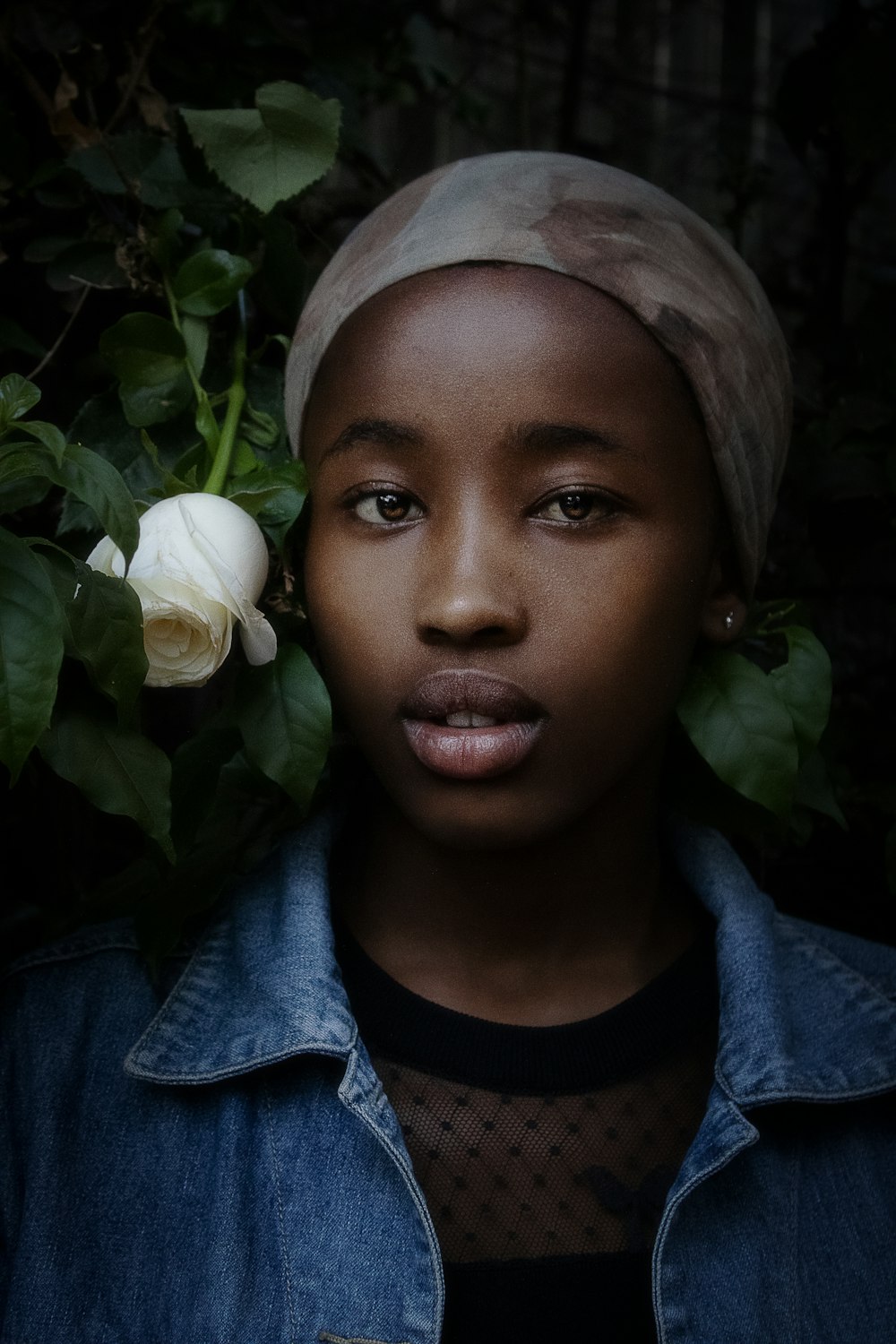 a woman with a turban and a rose in her hair