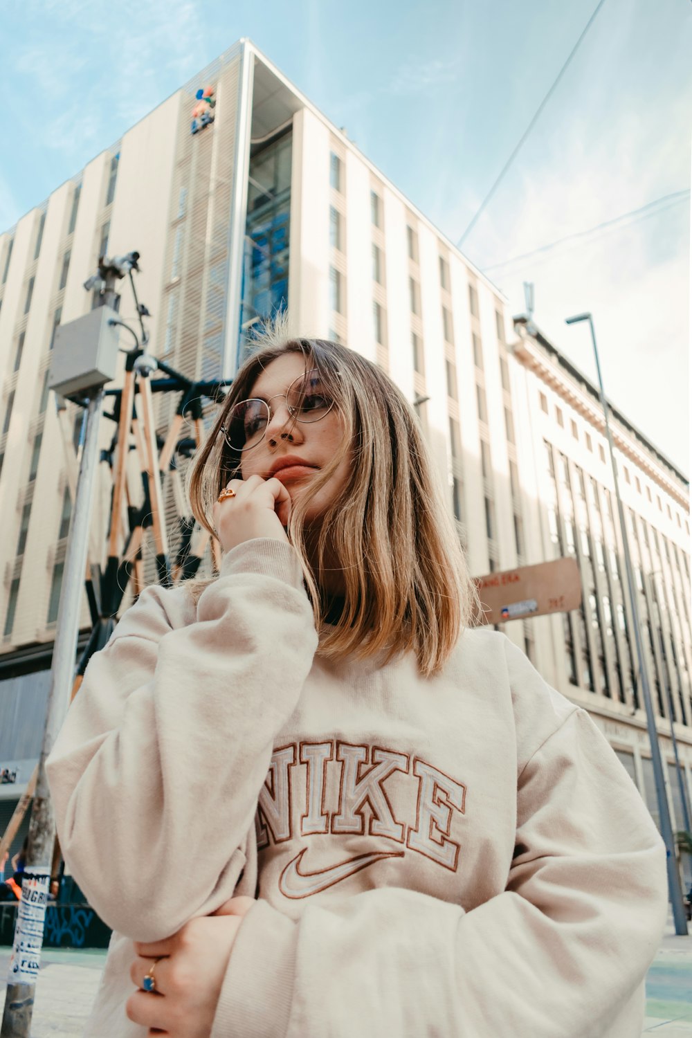 a woman standing in front of a building talking on a cell phone