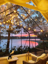 Cozy outdoor seating at sunset overlooking Lake Pichola, with warm lanterns glowing.