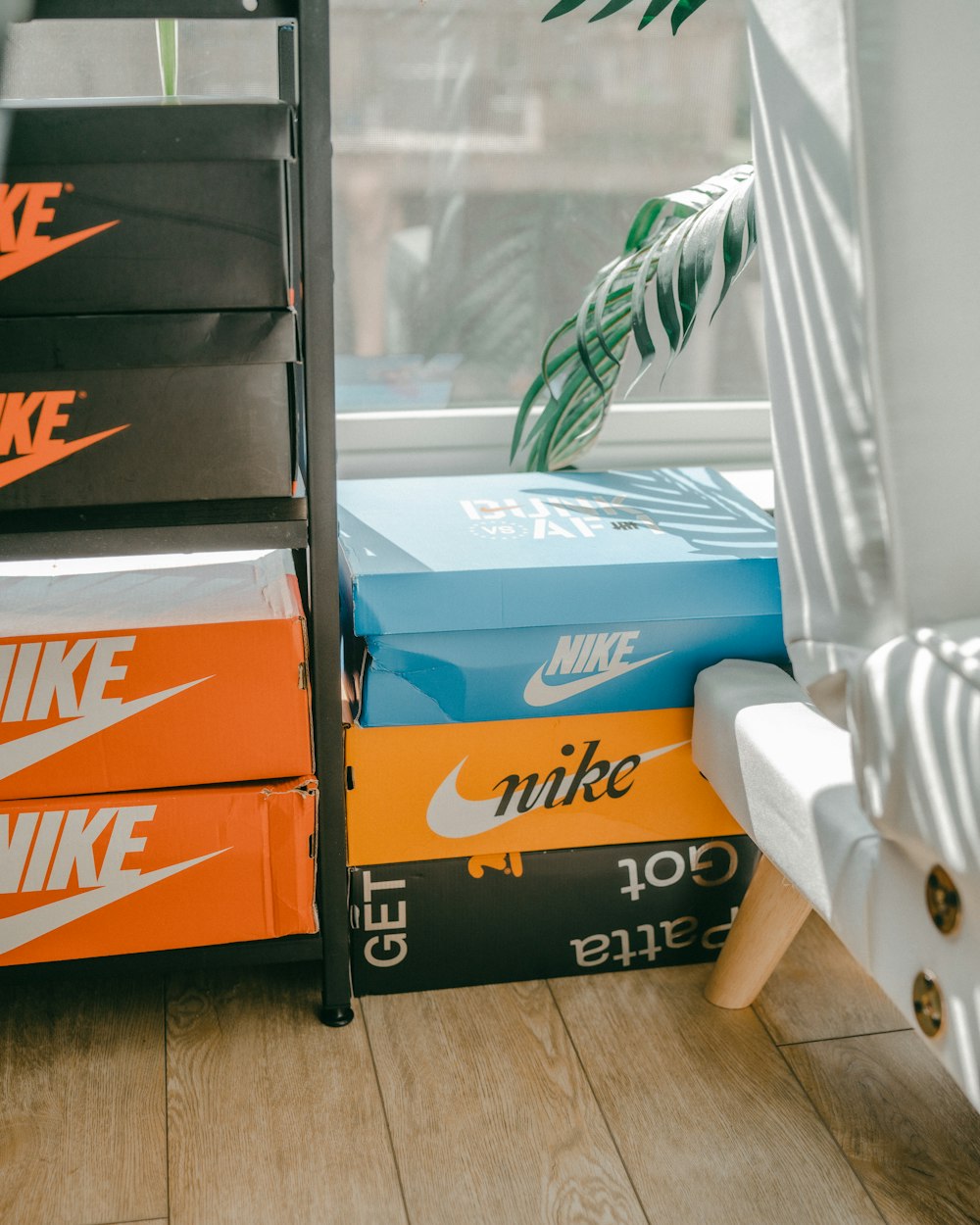 a stack of nike boxes sitting on top of a wooden floor