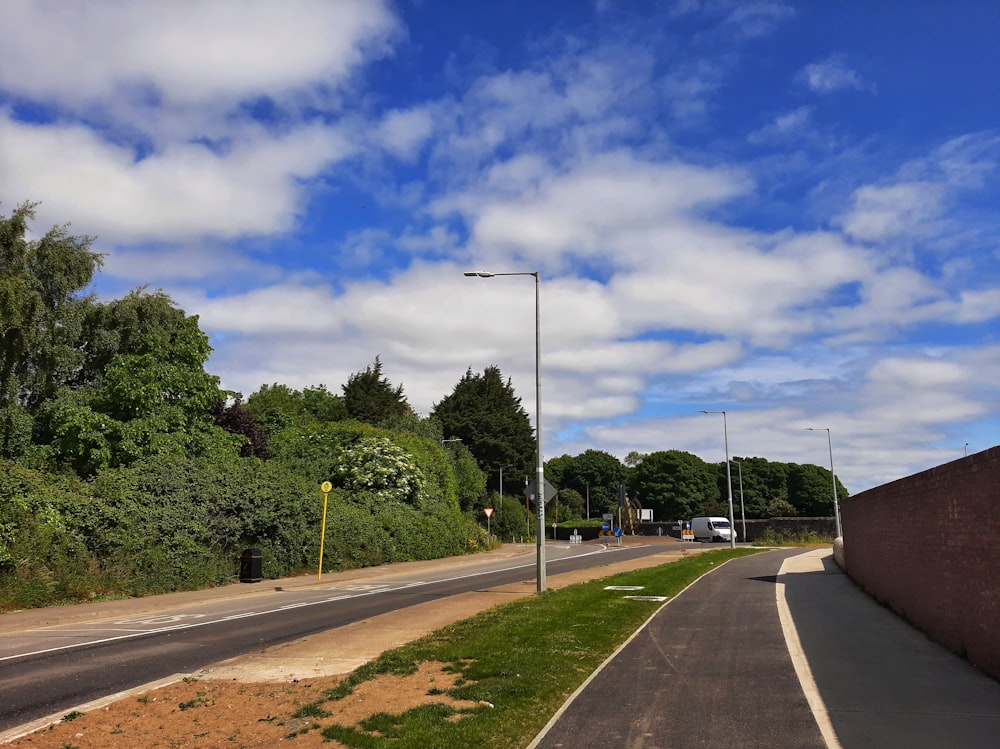 a street with a street light and a street sign on the side of the road