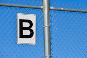 a white and black sign on a metal pole