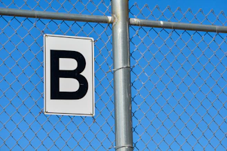 a white and black sign on a metal pole