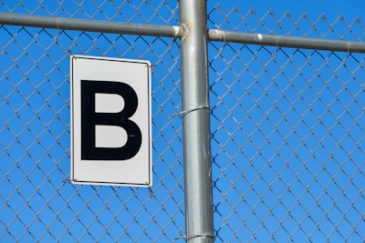 a white and black sign on a metal pole