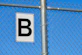 a white and black sign on a metal pole