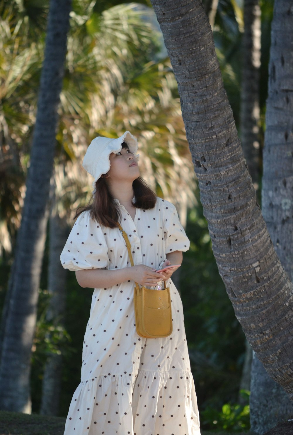 a woman wearing a white dress and a white hat