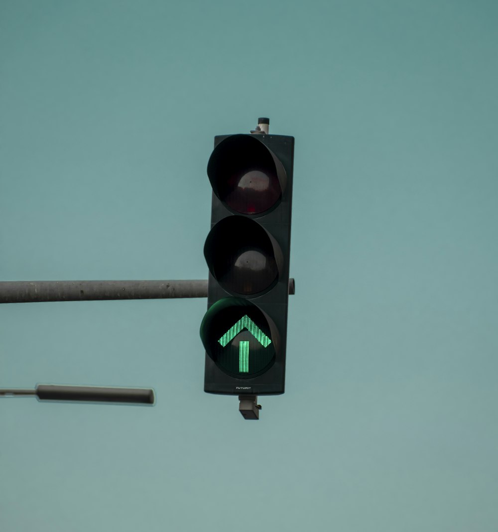 a traffic light with a green arrow on it