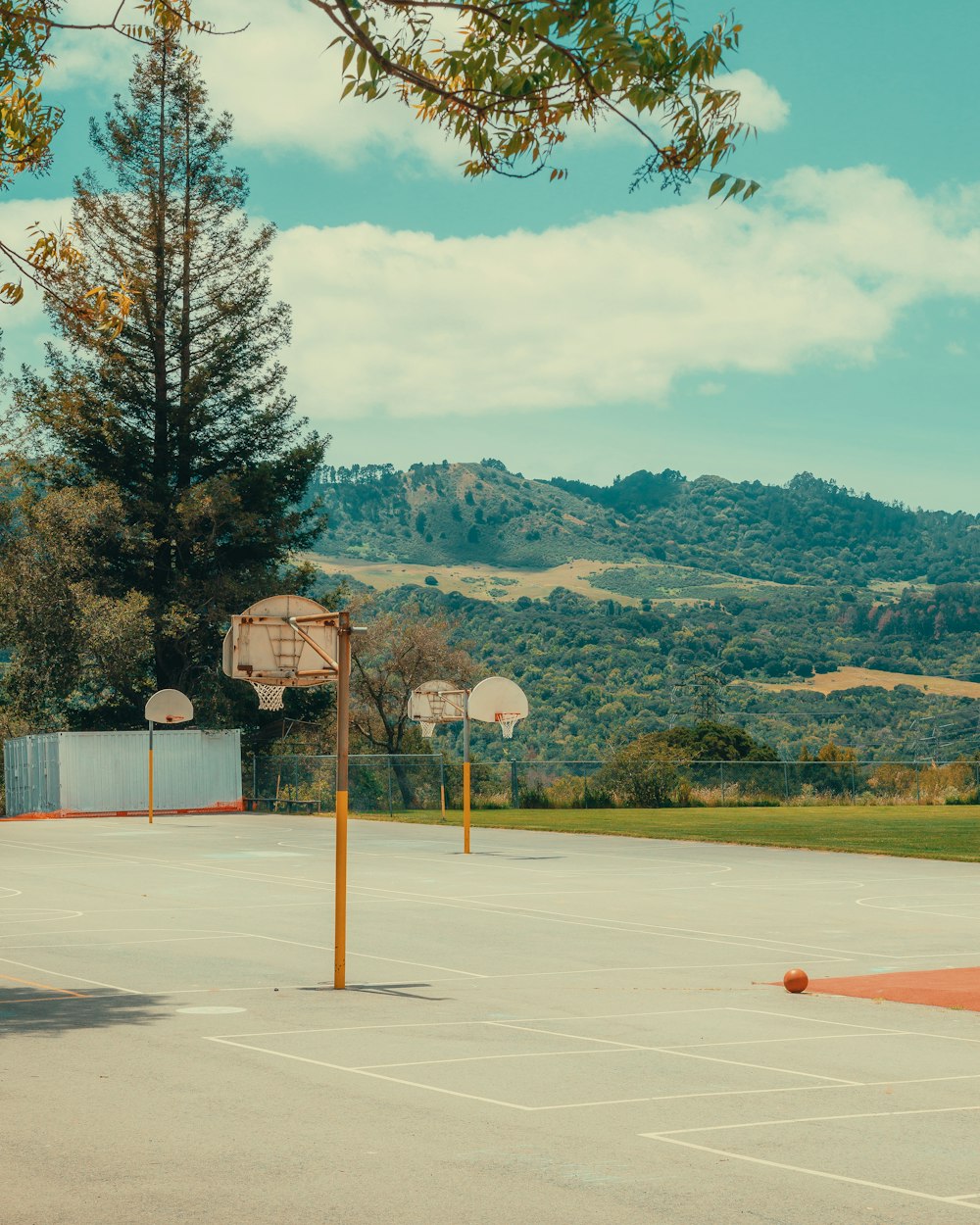 a basketball court with two basketballs in the middle of it