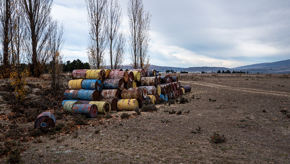 a bunch of barrels sitting in the middle of a field