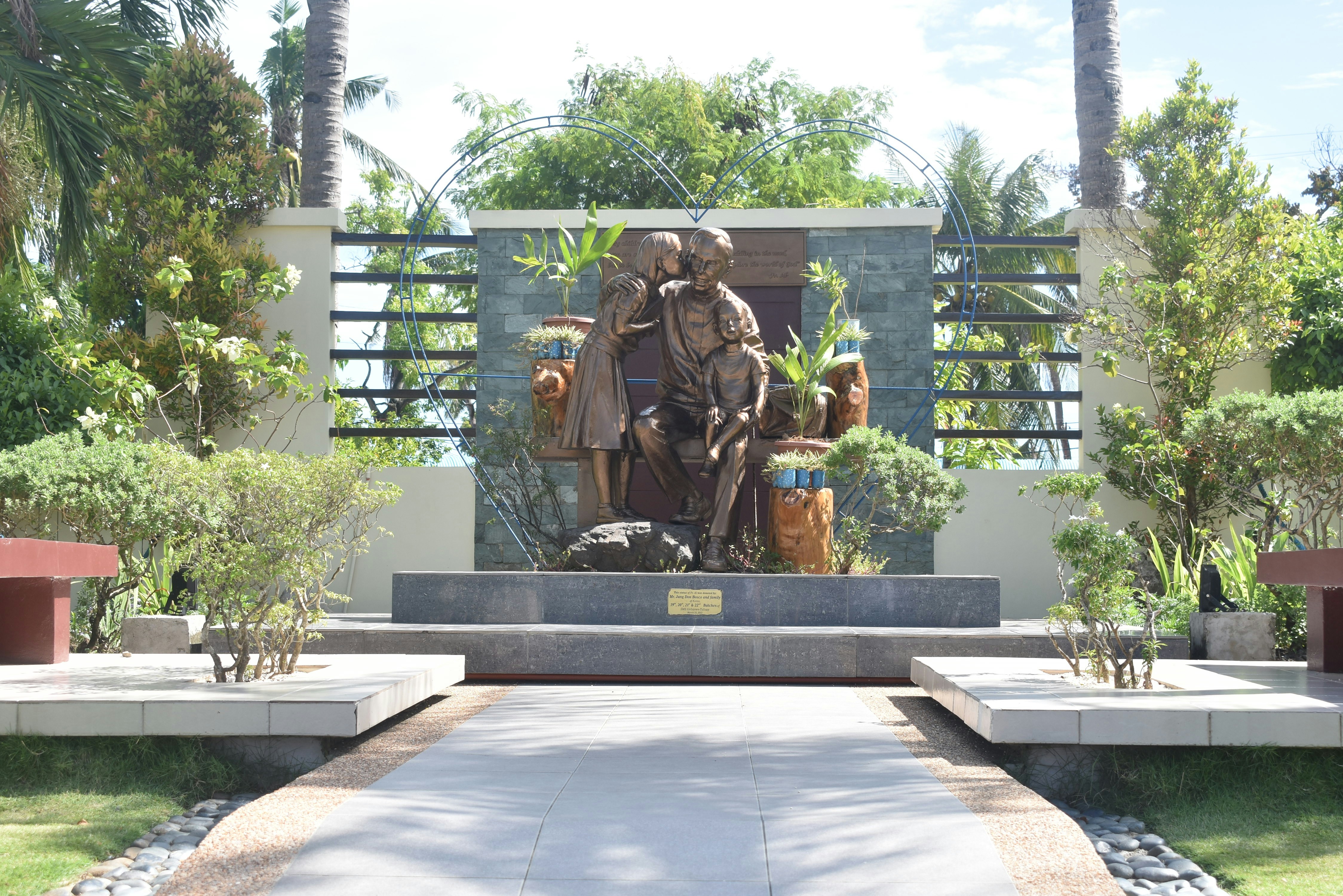 a statue of a man sitting on a bench