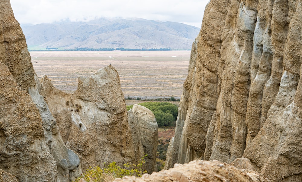 a view of a rocky landscape with mountains in the distance