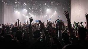 Fans holding up their phones capturing Mike’s energetic live show.